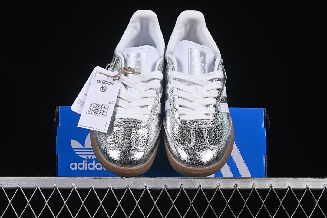 Front view of the sneakers displayed on a blue Adidas box