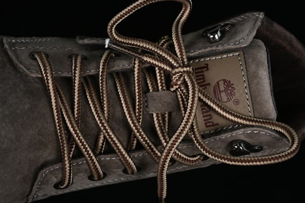 Close-up of the boot's laces, tongue and metal lace hardware.