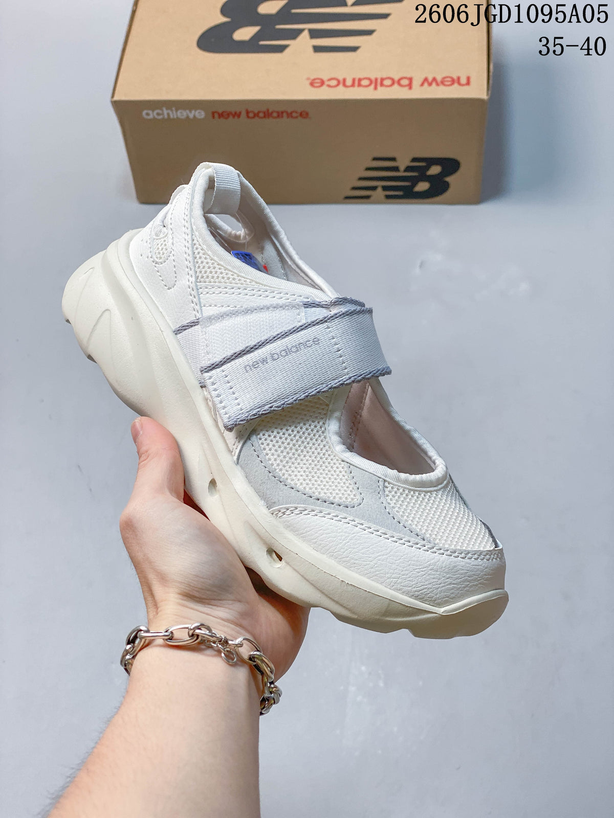 Angled view of a white New Balance Breeze Mary Jane sneaker with light gray accents