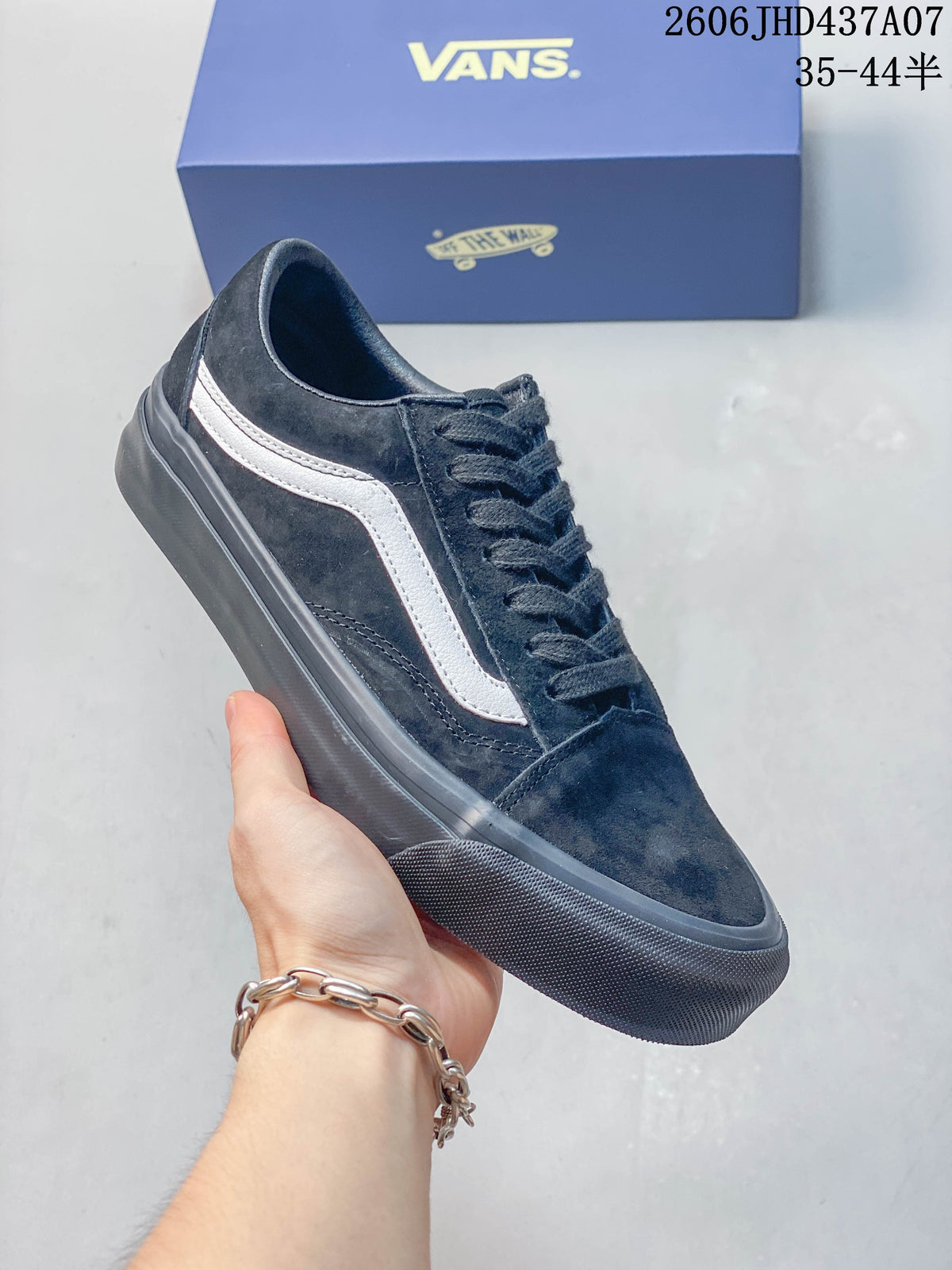 Angled side view of the black sneaker with a white stripe and dark outsole.