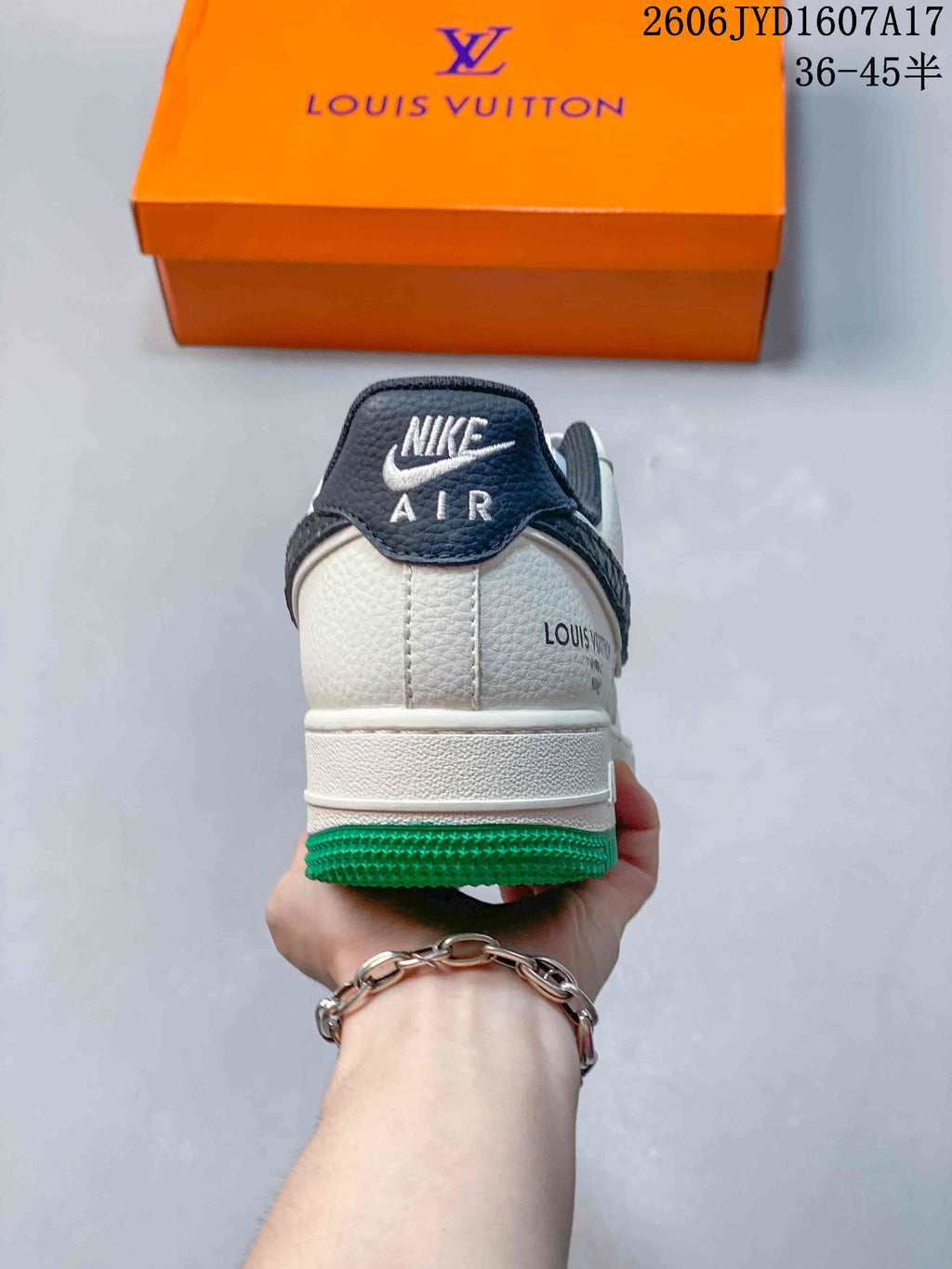Rear view showing the off-white heel, dark collar and green outsole