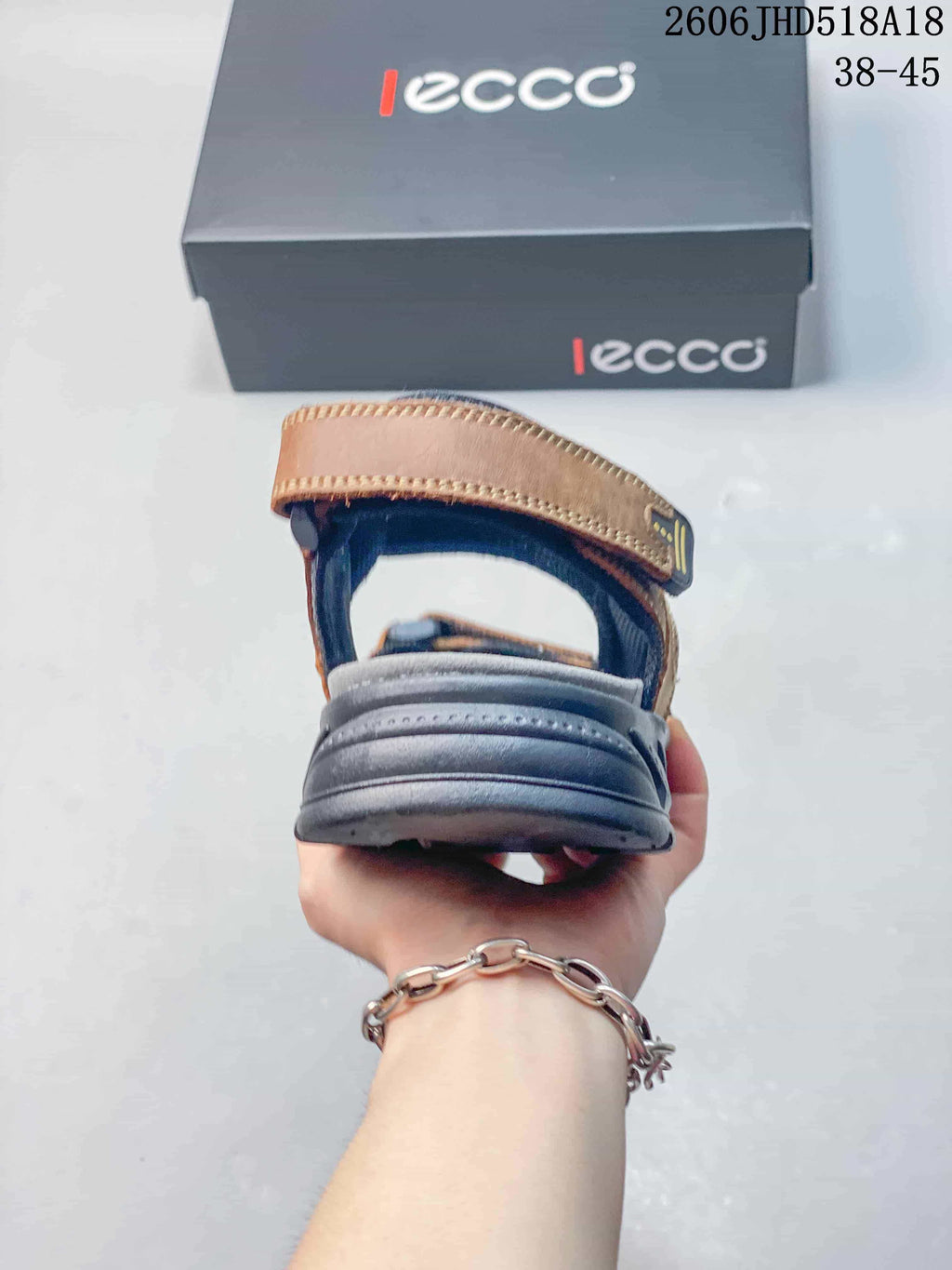 Rear view showing the heel strap and raised gray outsole of the sandal.
