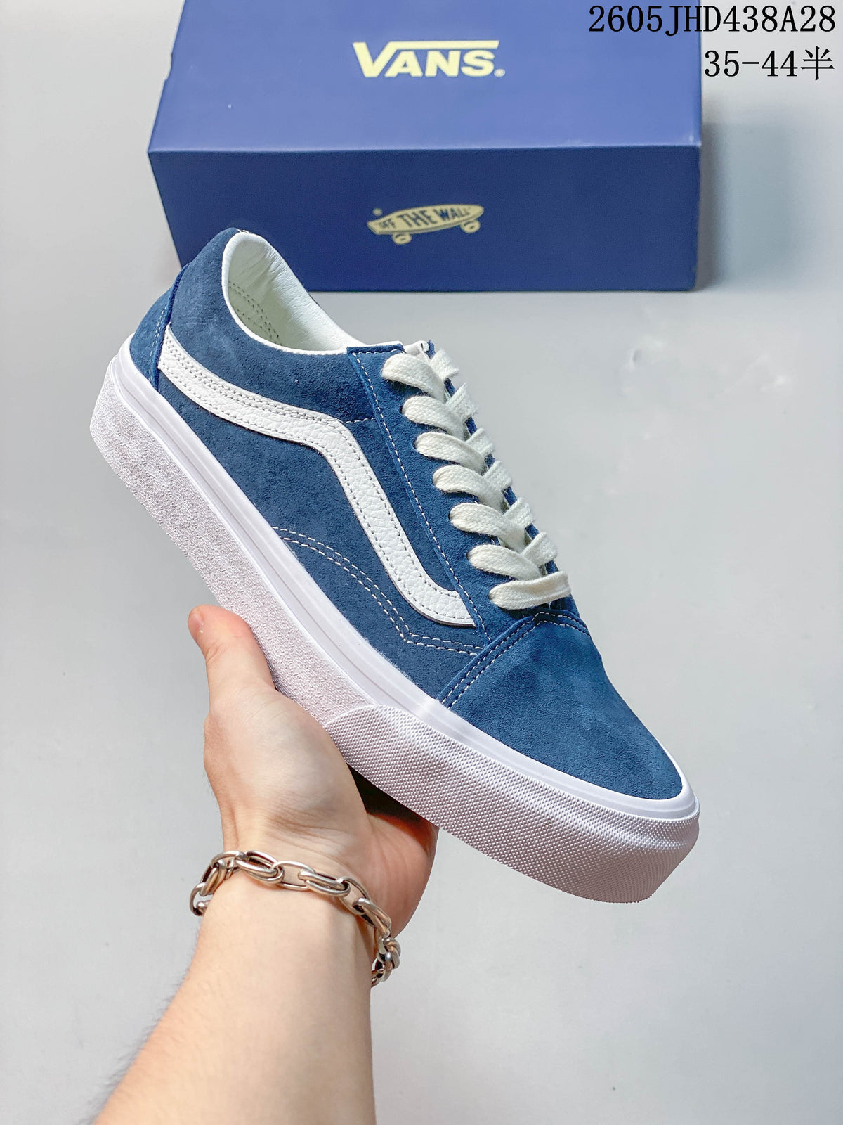 Blue low-top sneaker shown from the side, with a white stripe, laces and rubber sole.