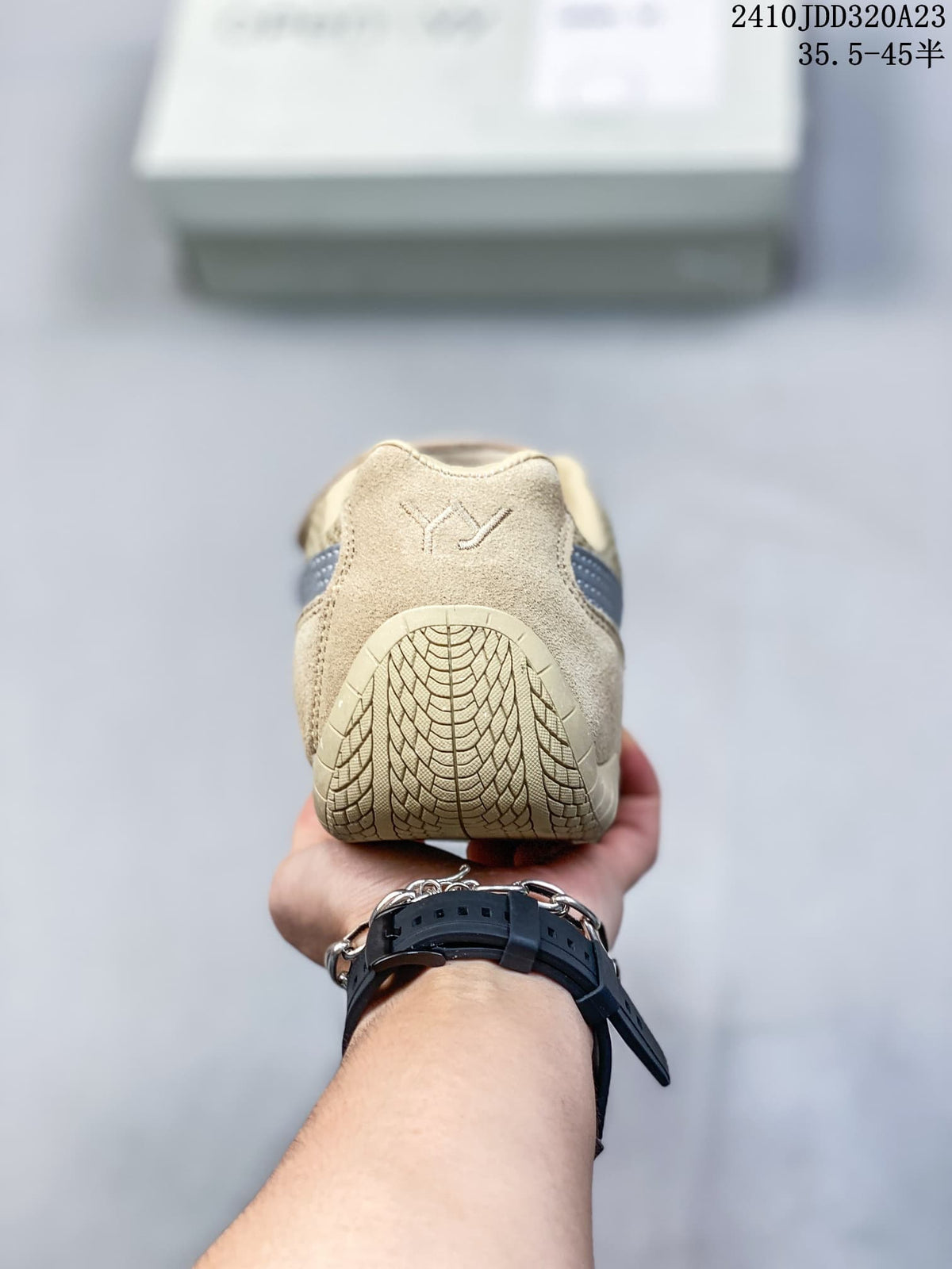 Rear view showing the heel and outsole pattern of the beige sneaker.