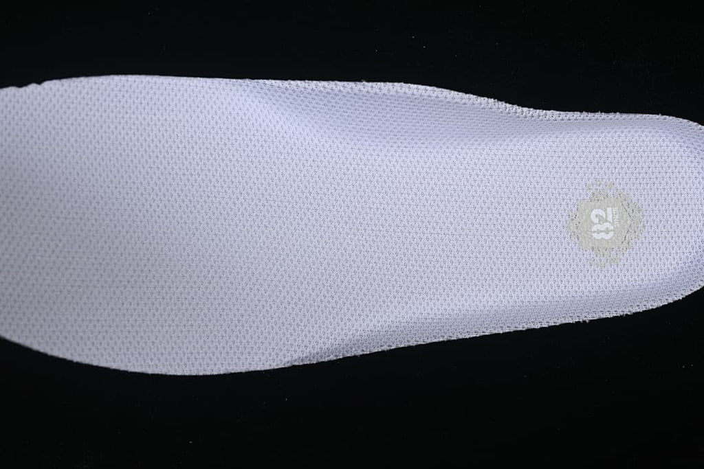 Close-up of the white insole with a small printed emblem.