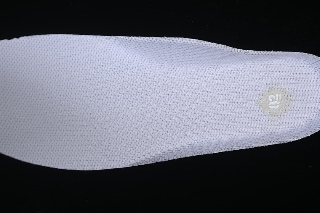 Close-up of the white insole with a small printed emblem.