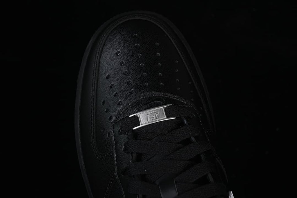 Top close-up of the perforated toe, black laces, and metal lace tag