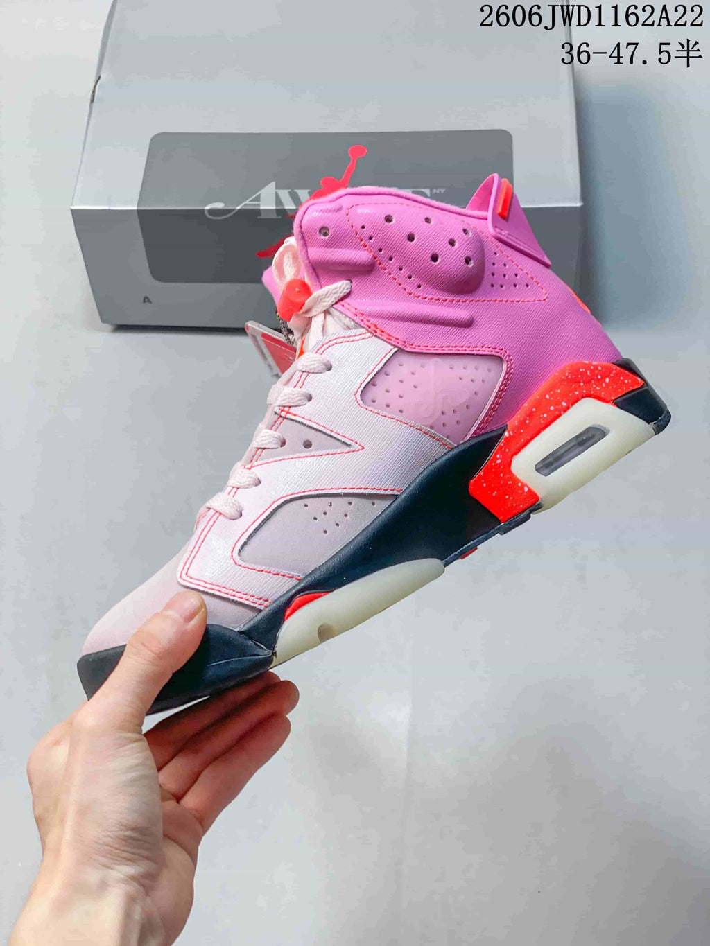 Side view of the pink Air Jordan 6 showing perforated panels and contrasting midsole accents