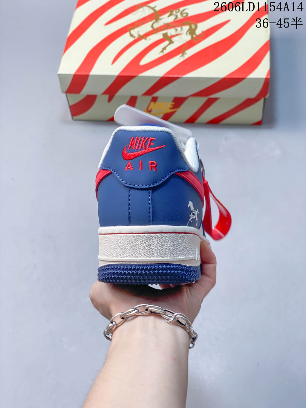 Rear view of the blue and white sneaker with red detailing