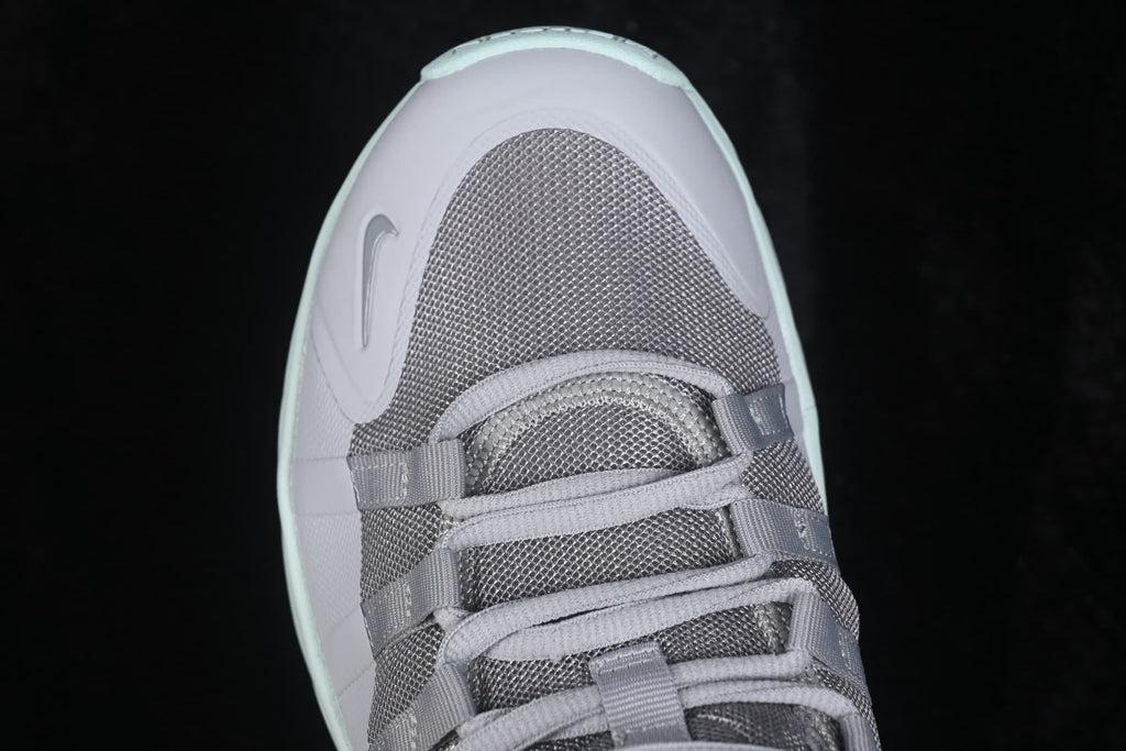 Close-up view of the gray mesh toe box and lace-up fastening.