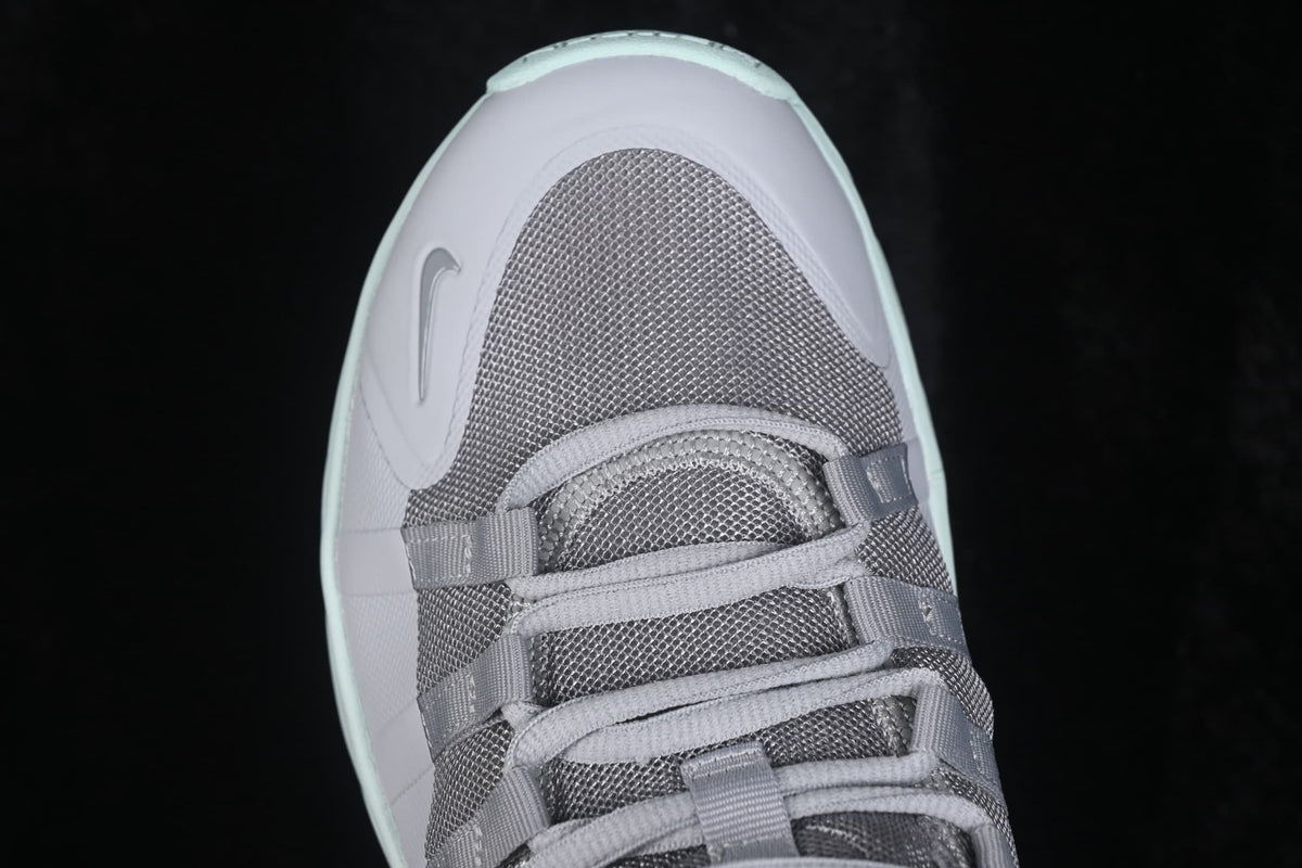 Close-up view of the gray mesh toe box and lace-up fastening.