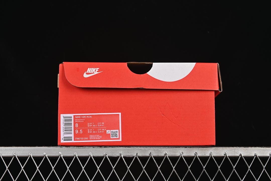 Shoe box label showing Nike V2K Run, model FN6703-200, and sample size details