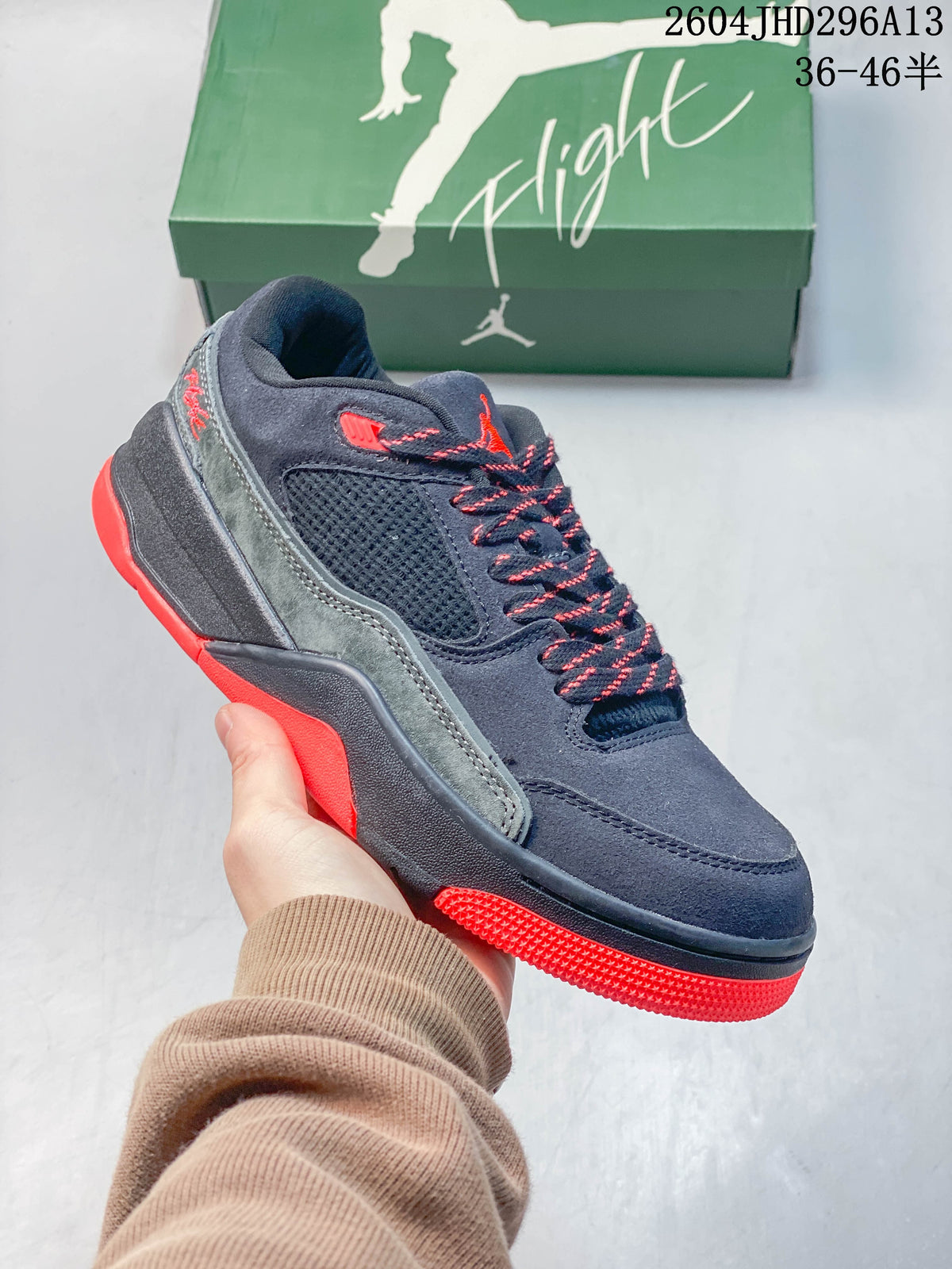 Angled side view highlighting the sneaker's navy upper, gray panel, mesh section, and red outsole.