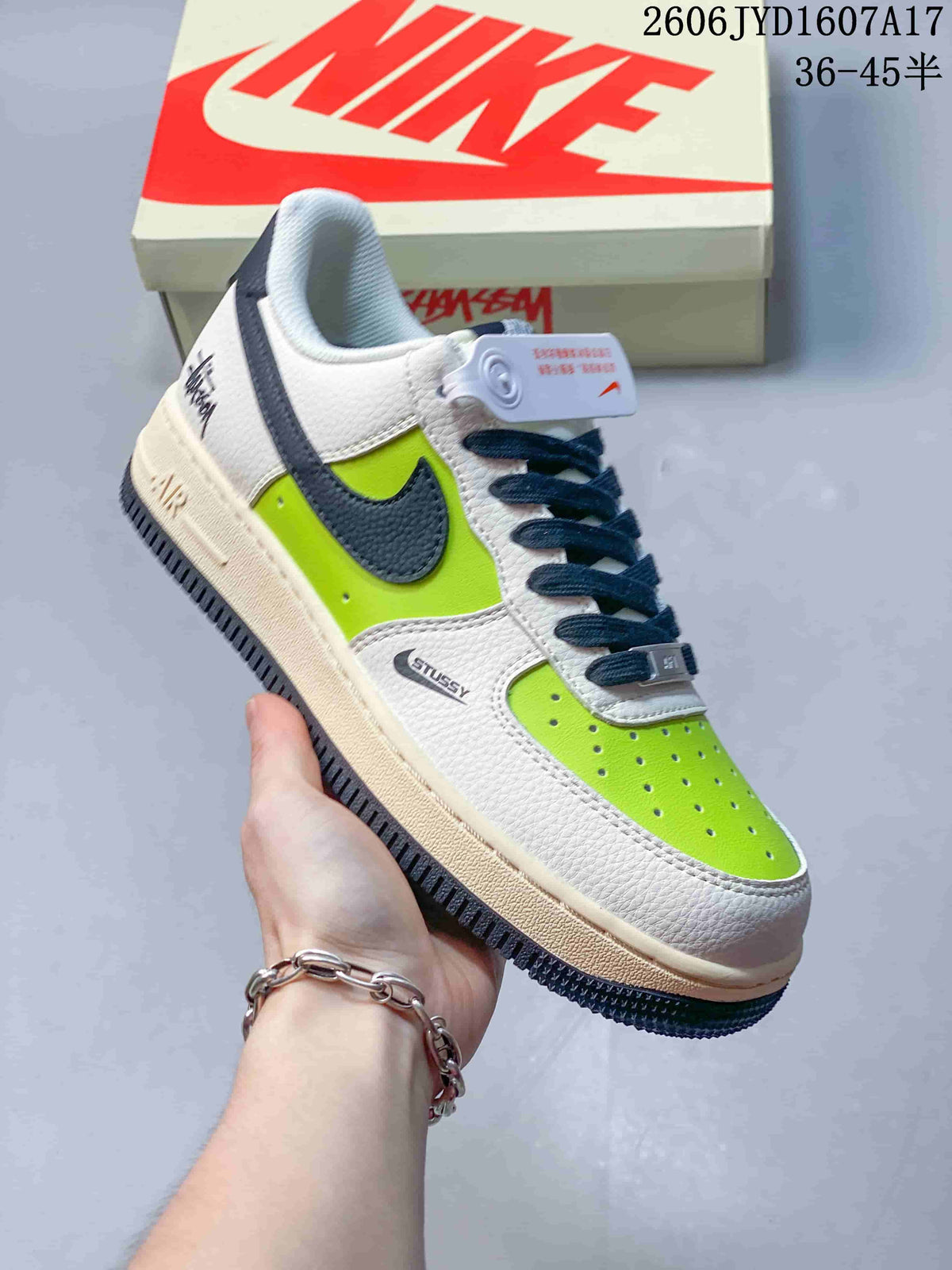 Angled view of the sneaker showing its white and lime upper, navy details and off-white midsole.