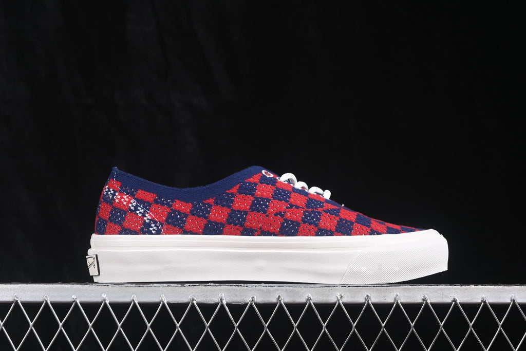 Side profile showing the check-pattern upper, low-top shape, white sidewall, and heel branding.