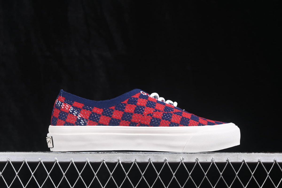 Side profile showing the check-pattern upper, low-top shape, white sidewall, and heel branding.
