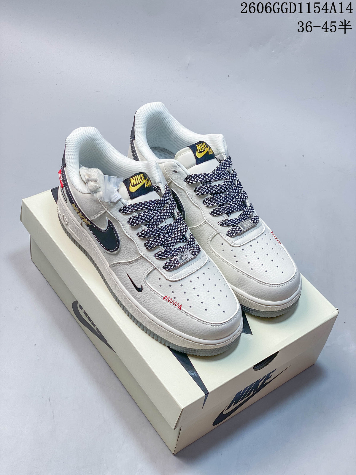Pair of off-white low-top sneakers with patterned laces, dark swooshes and contrasting tongue labels.