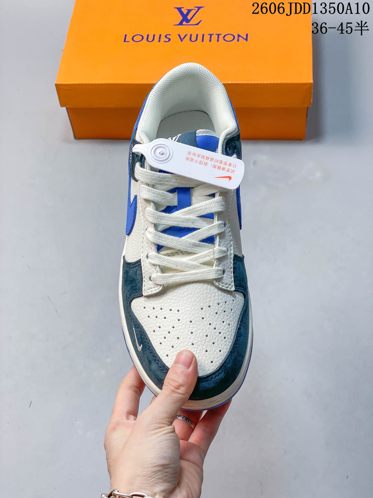 Top view of a low-top sneaker with white laces and a perforated toe
