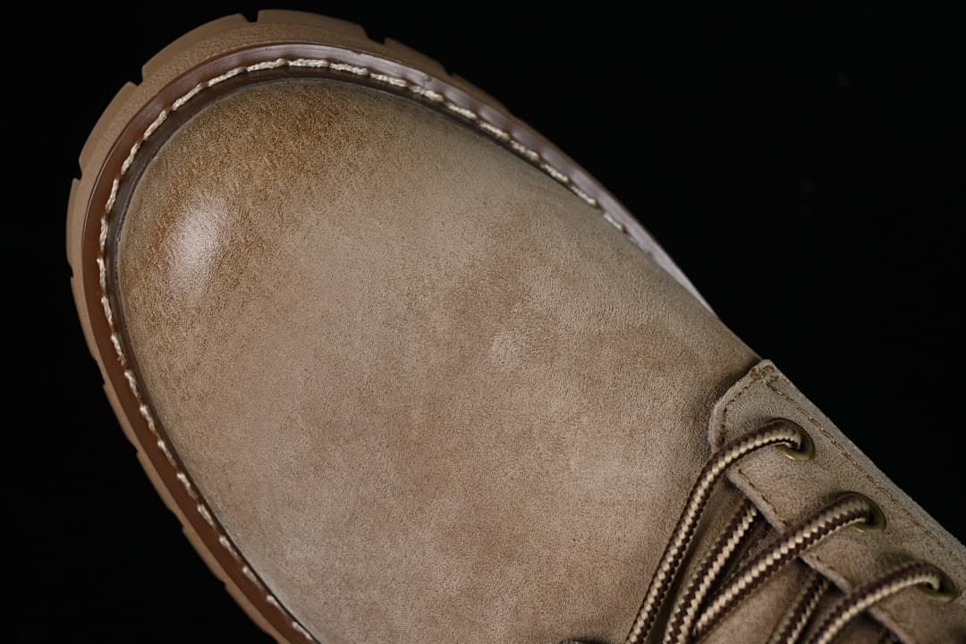 Top-down close-up of the rounded khaki toe and stitched welt.