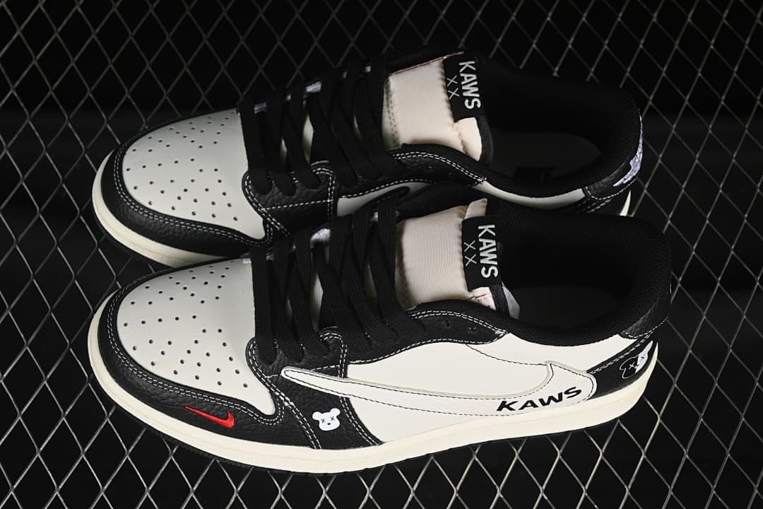 Top view of a pair of black-and-white low-top sneakers with perforated toe panels and black laces