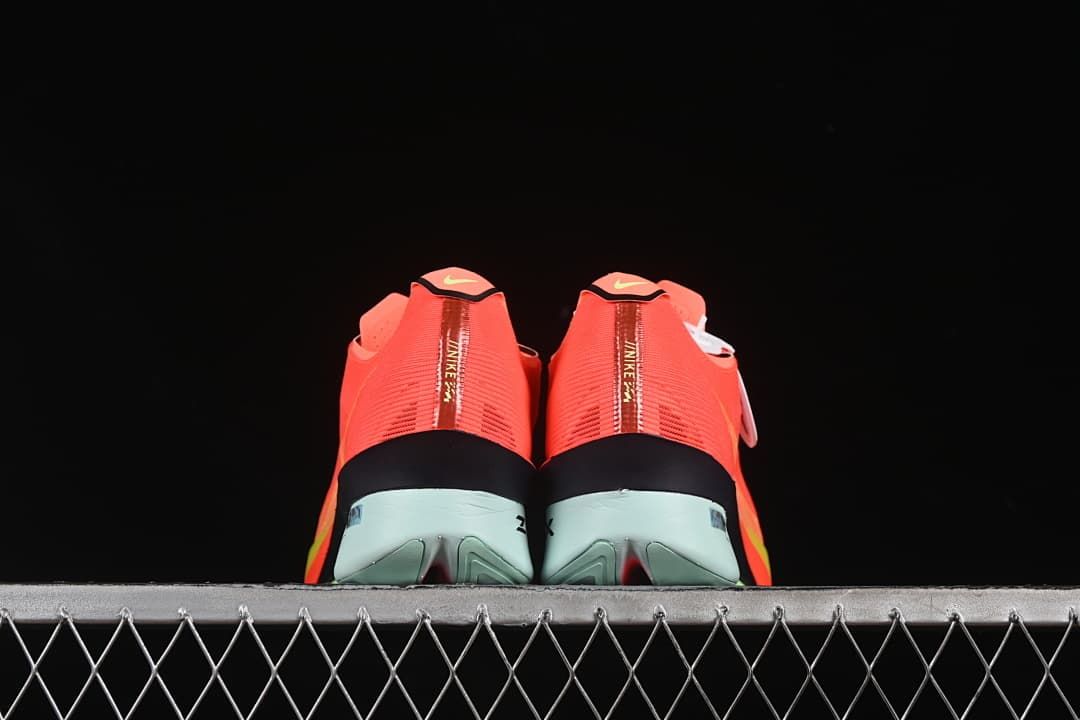 Rear view of the pair showing the heel strips and pale mint-toned midsoles.