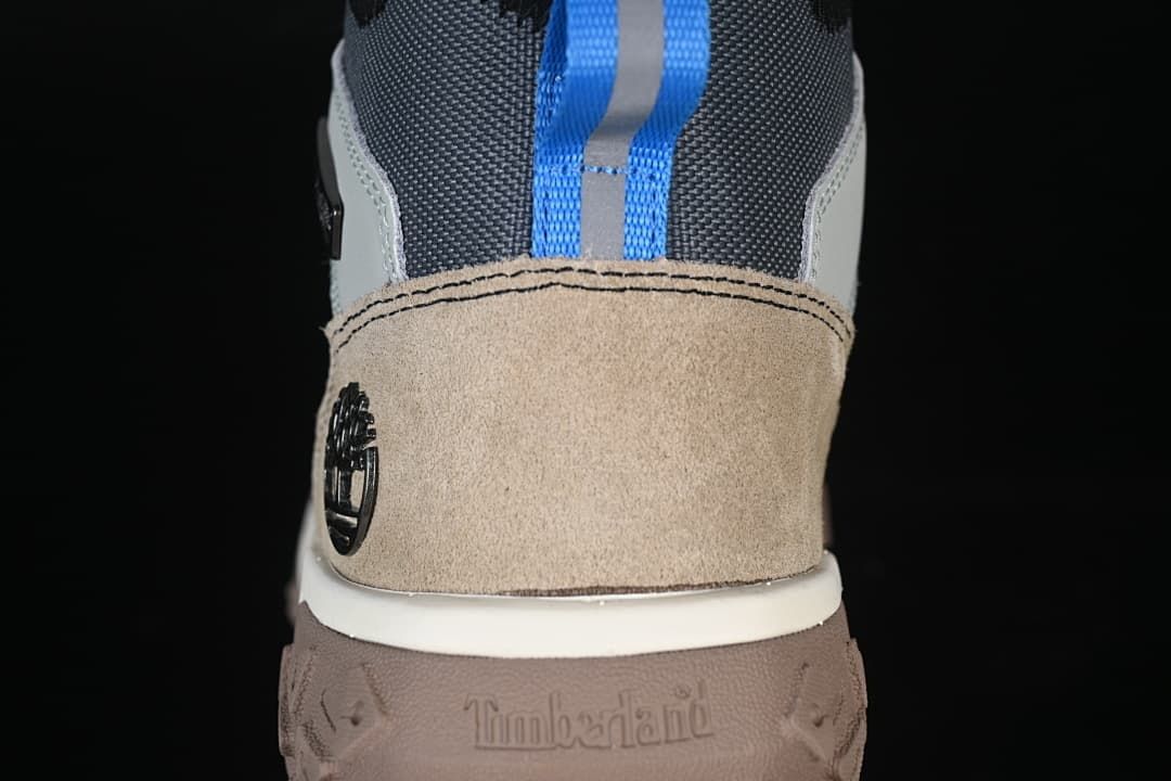 Rear view highlighting the tan heel panel and blue pull loop