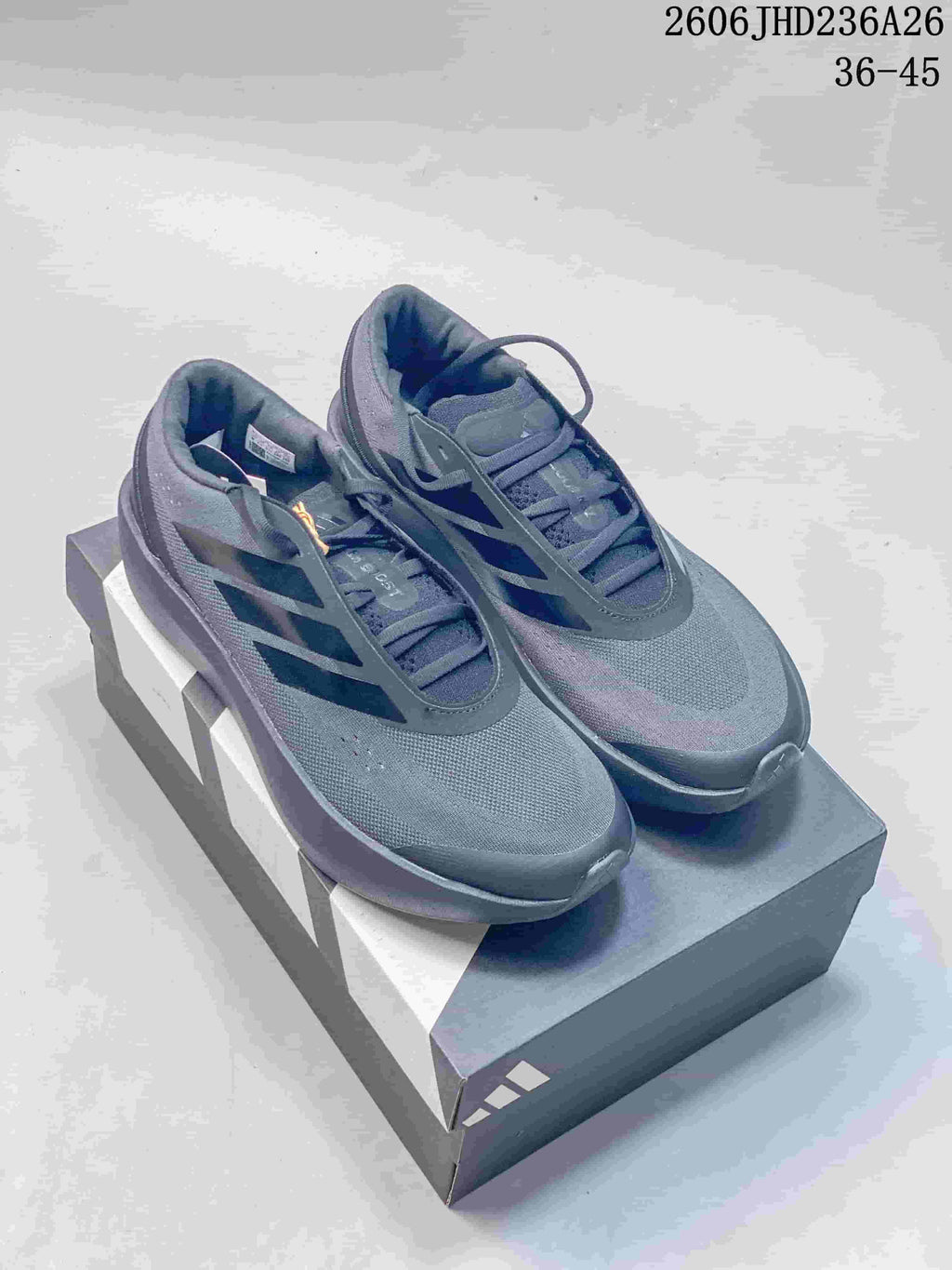 Dark gray adidas ZENBOOST low-top shoes with dark side stripes.