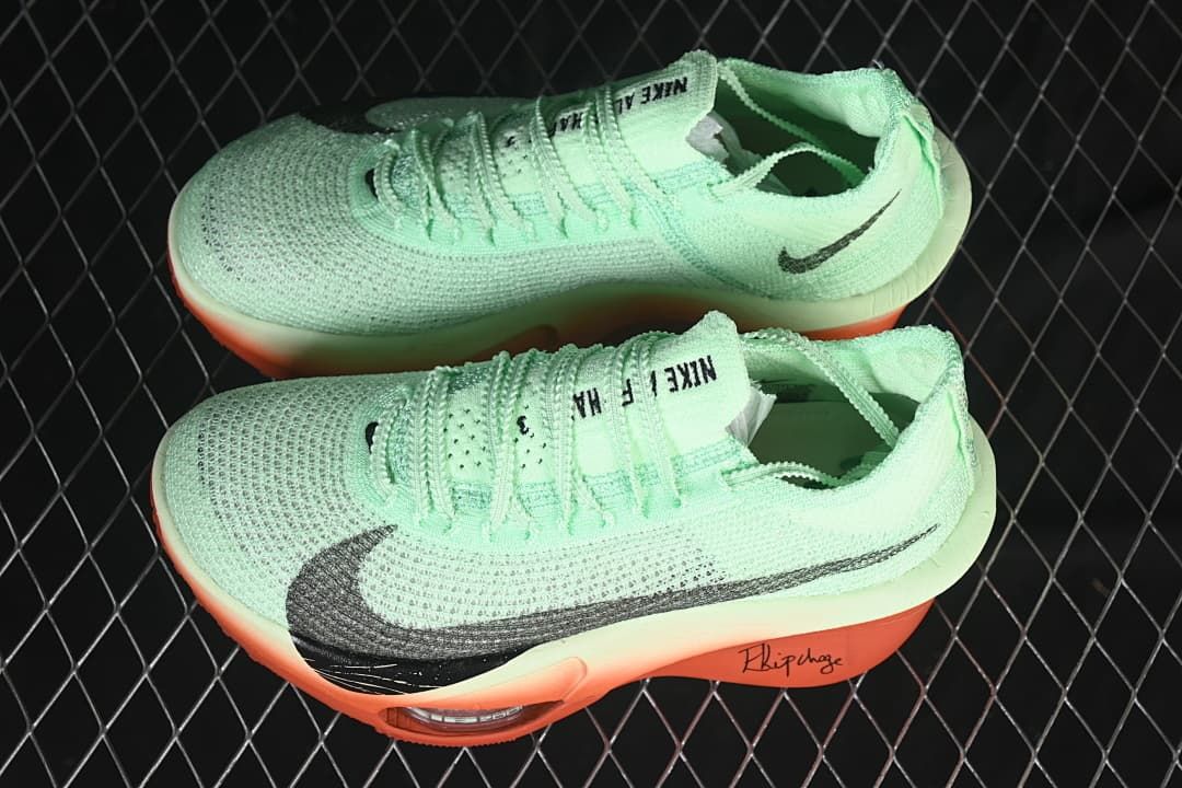 Pair of mint and coral Nike running shoes in a side view