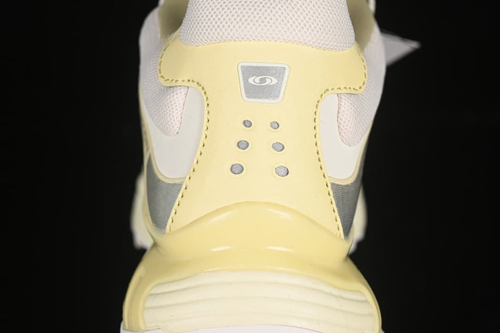 Rear view of the shoe showing yellow heel details and mesh panels