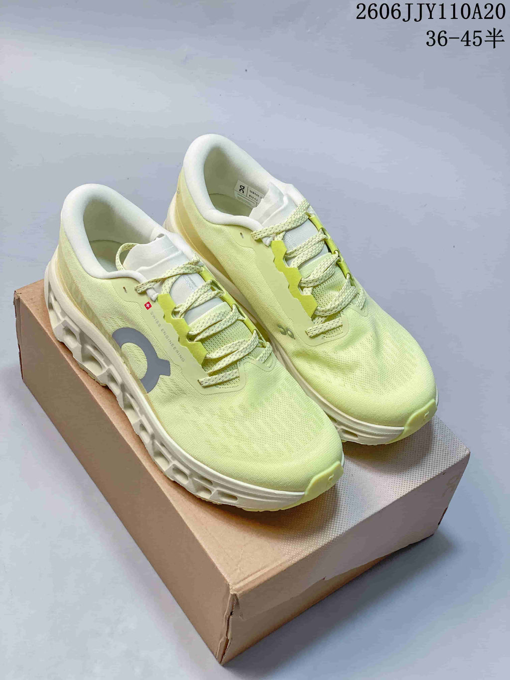 Pair of pale yellow On Cloudmonster 3 running shoes shown from above