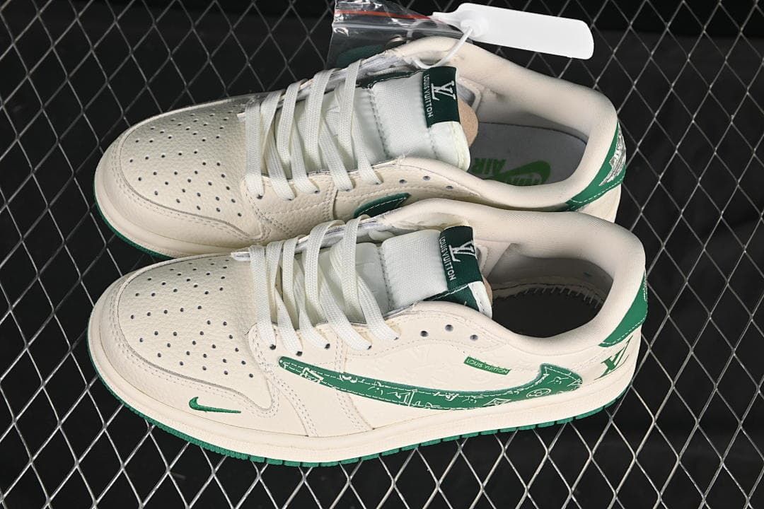 Pair of cream and green low-top sneakers shown from above, with perforated toes and white laces