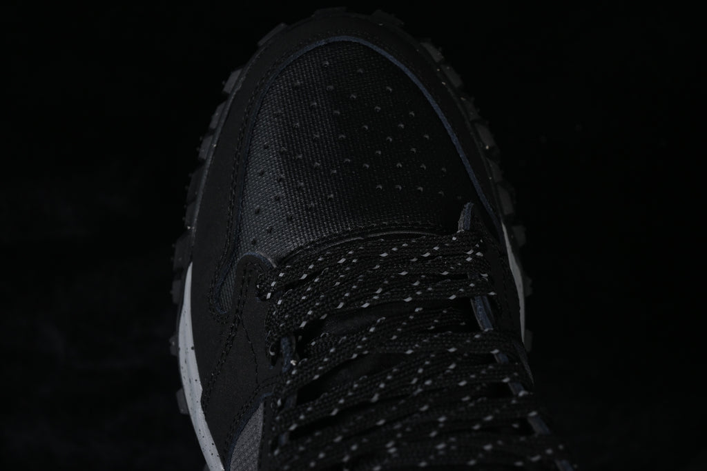Top-down close-up of the perforated toe and patterned black laces