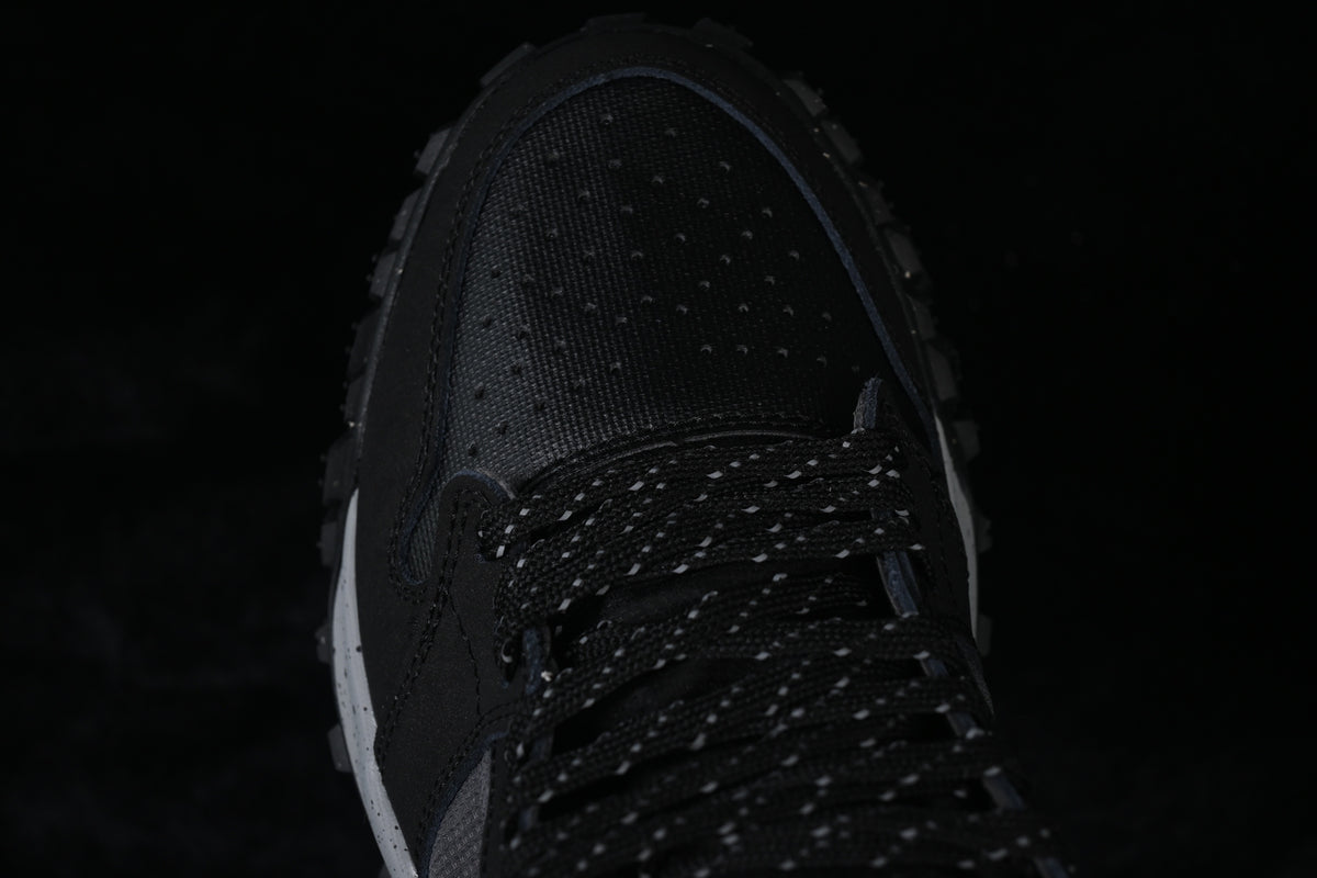 Top-down close-up of the perforated toe and patterned black laces