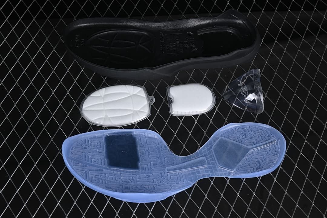 Outsole and detached shoe components shown beside a pale blue basketball shoe sole