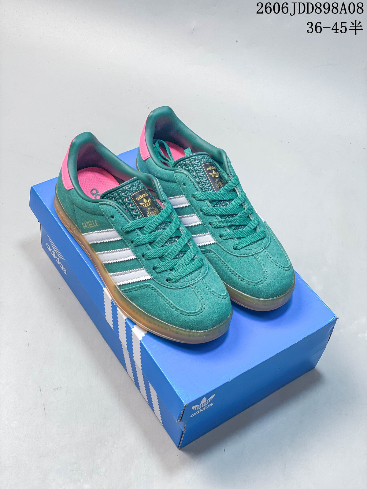 Teal Gazelle-style sneakers with white stripes and contrasting pink details