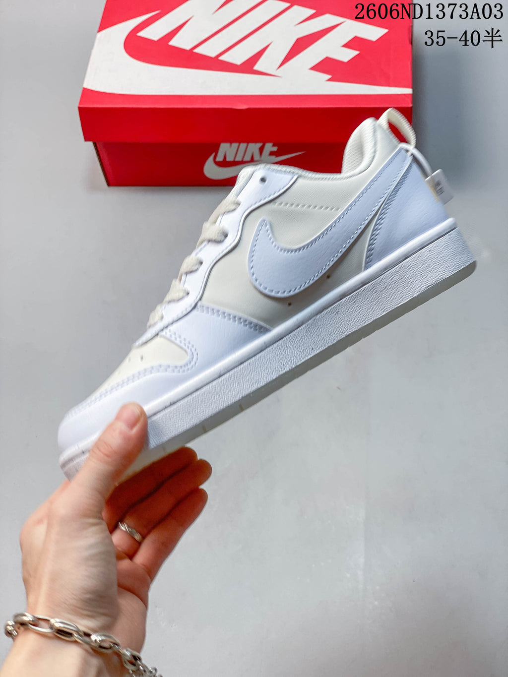 Side view of the white and pale blue low-top sneaker
