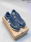Pair of navy Veja Esplar low sneakers with white side logos and light midsoles, displayed on a shoe box.