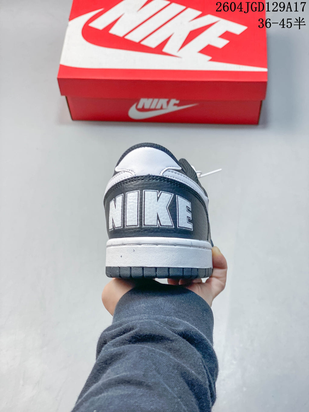 Heel view of a dark gray low-top sneaker with white Nike lettering