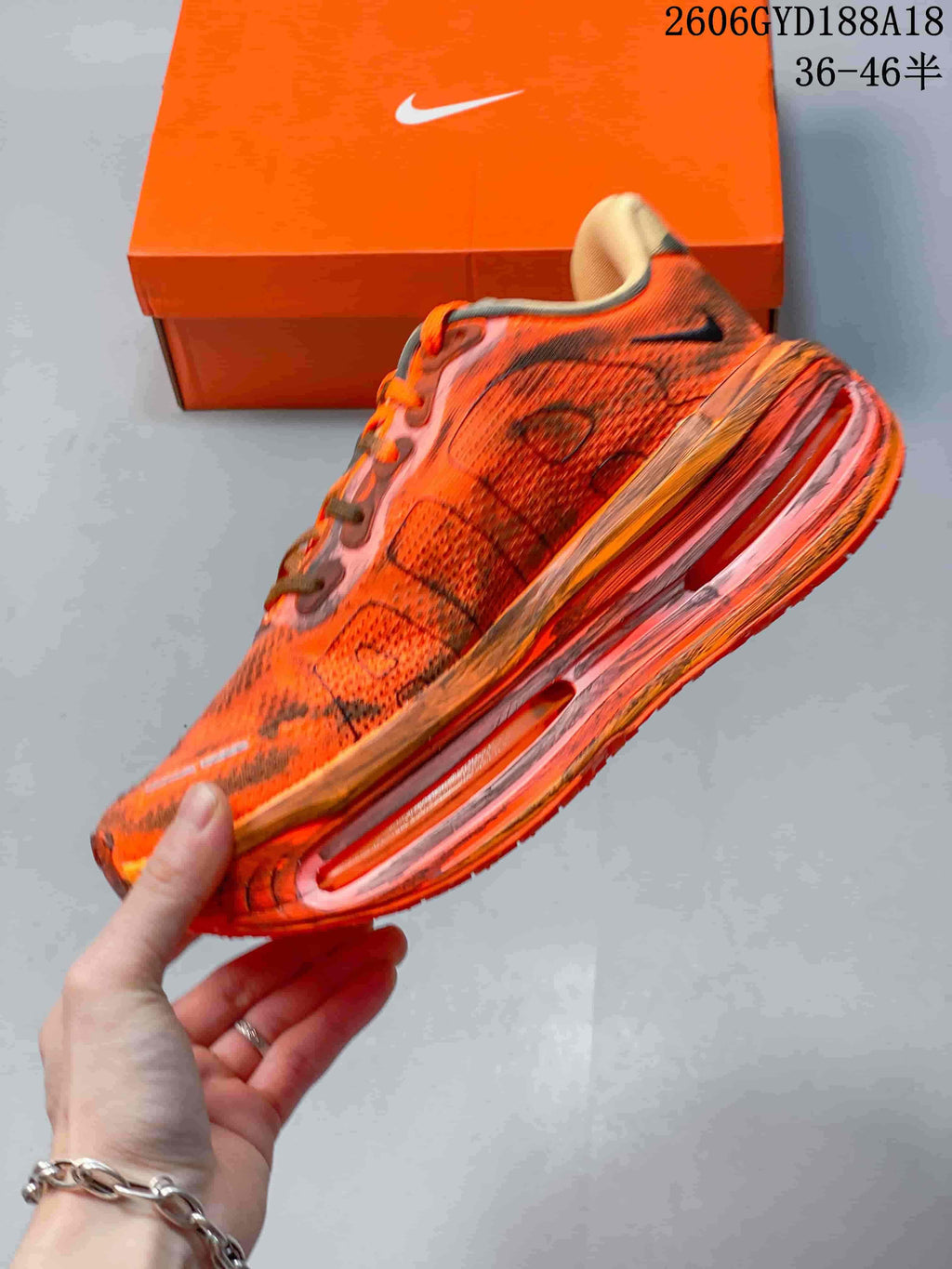 Side view of an orange Nike Air Pegasus Premium sneaker with a sculpted sole.