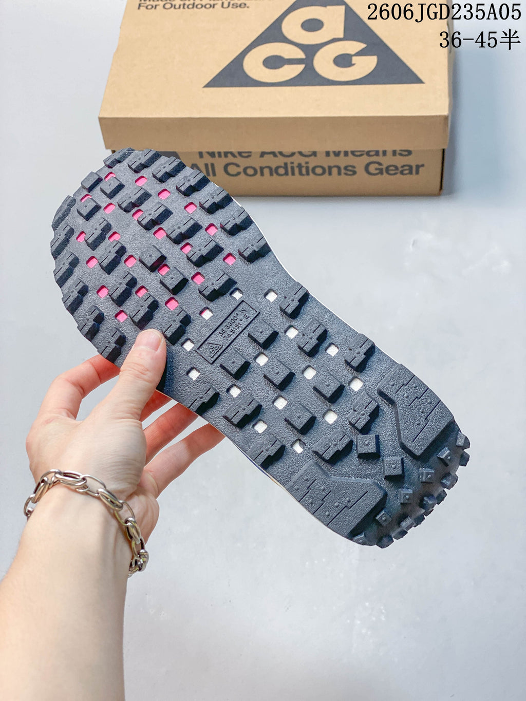 Close-up of the dark lugged outsole on a Nike ACG shoe