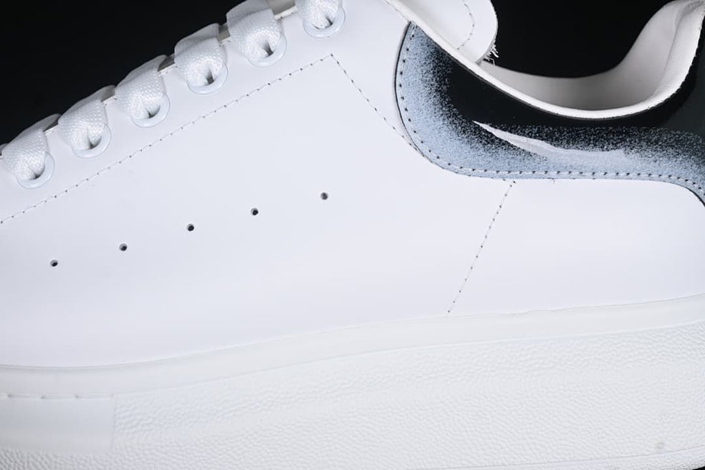 Close-up of the white side panel, perforations, laces, and gradient heel detail