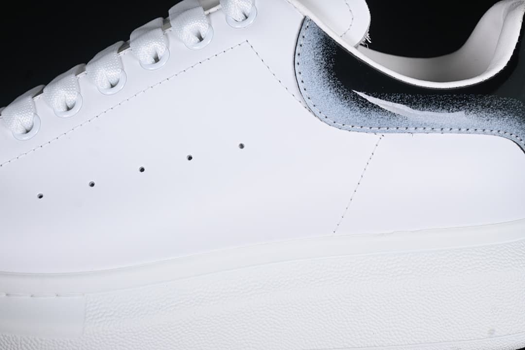 Close-up of the white side panel, perforations, laces, and gradient heel detail