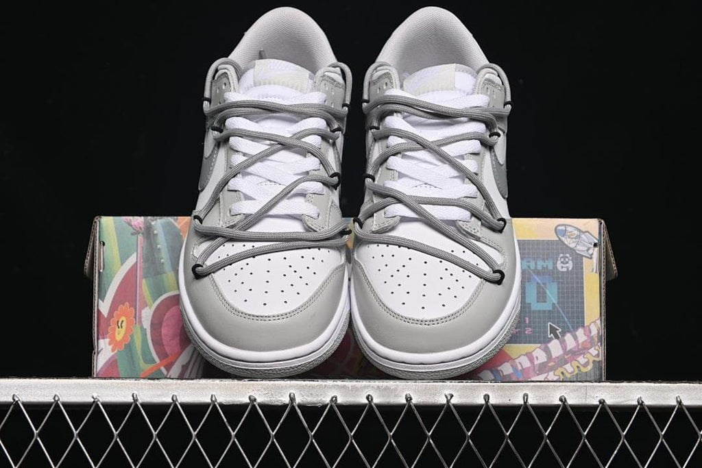 Front view of the sneaker pair displayed on the box