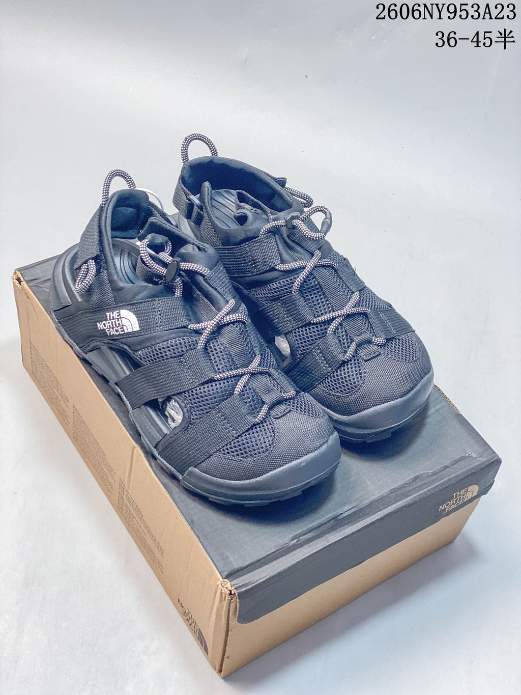 Pair of black The North Face Explore Camp open-toe sandals displayed on a shoe box.
