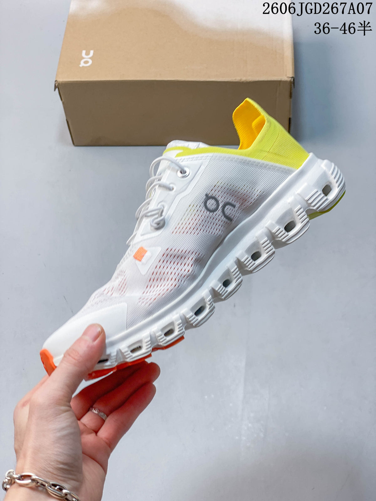 Side view of the white sneaker with yellow heel detail and orange accents