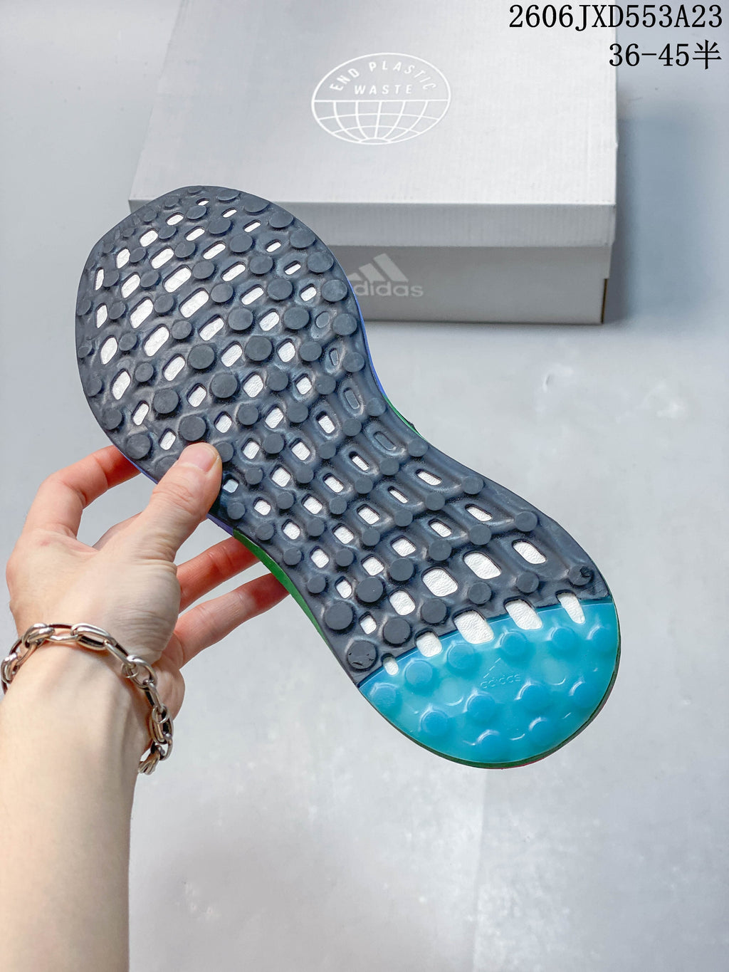 Close-up of the patterned outsole on the Adidas PureBoost 21 shoe
