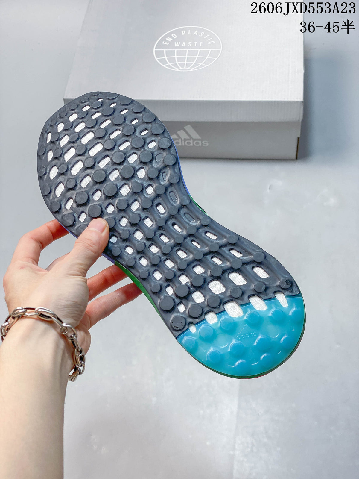Close-up of the patterned outsole on the Adidas PureBoost 21 shoe