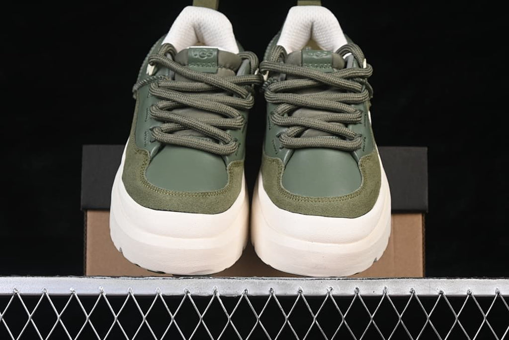 Front view of the pair showing green uppers, laces and chunky off-white soles