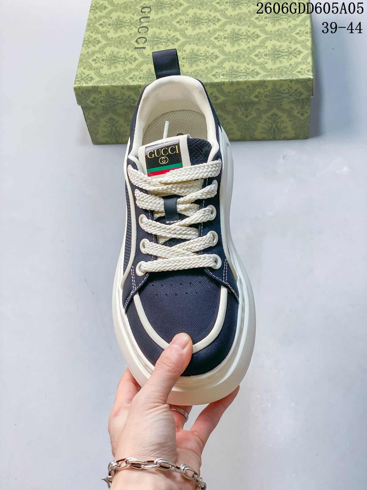 Top view of a navy sneaker with white laces and contrast trim