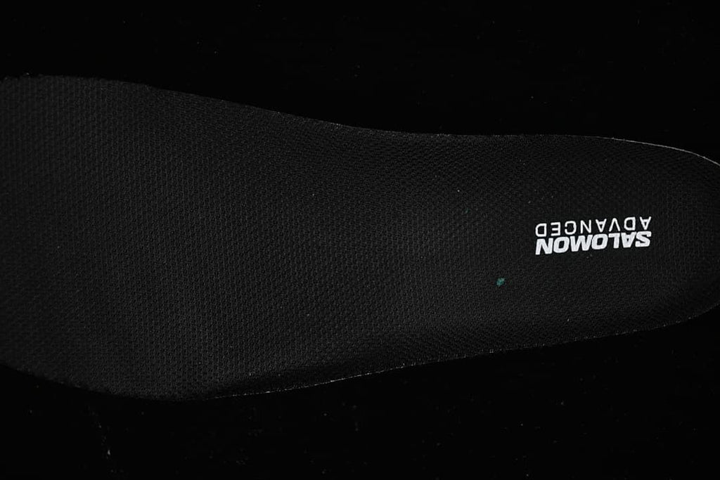 Close-up of the black insole with Salomon Advanced branding
